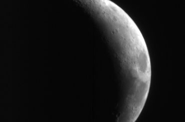 This image shows a crescent view of Earth's Moon in red wavelengths.