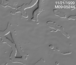 This is a black and white animated image that highlights the recession of the carbon dioxide layers at Mars' south polar cap over the last six years.  The images move in a time-lapse fashion, making it appear that holes and pits are becoming larger as the viewer watches.