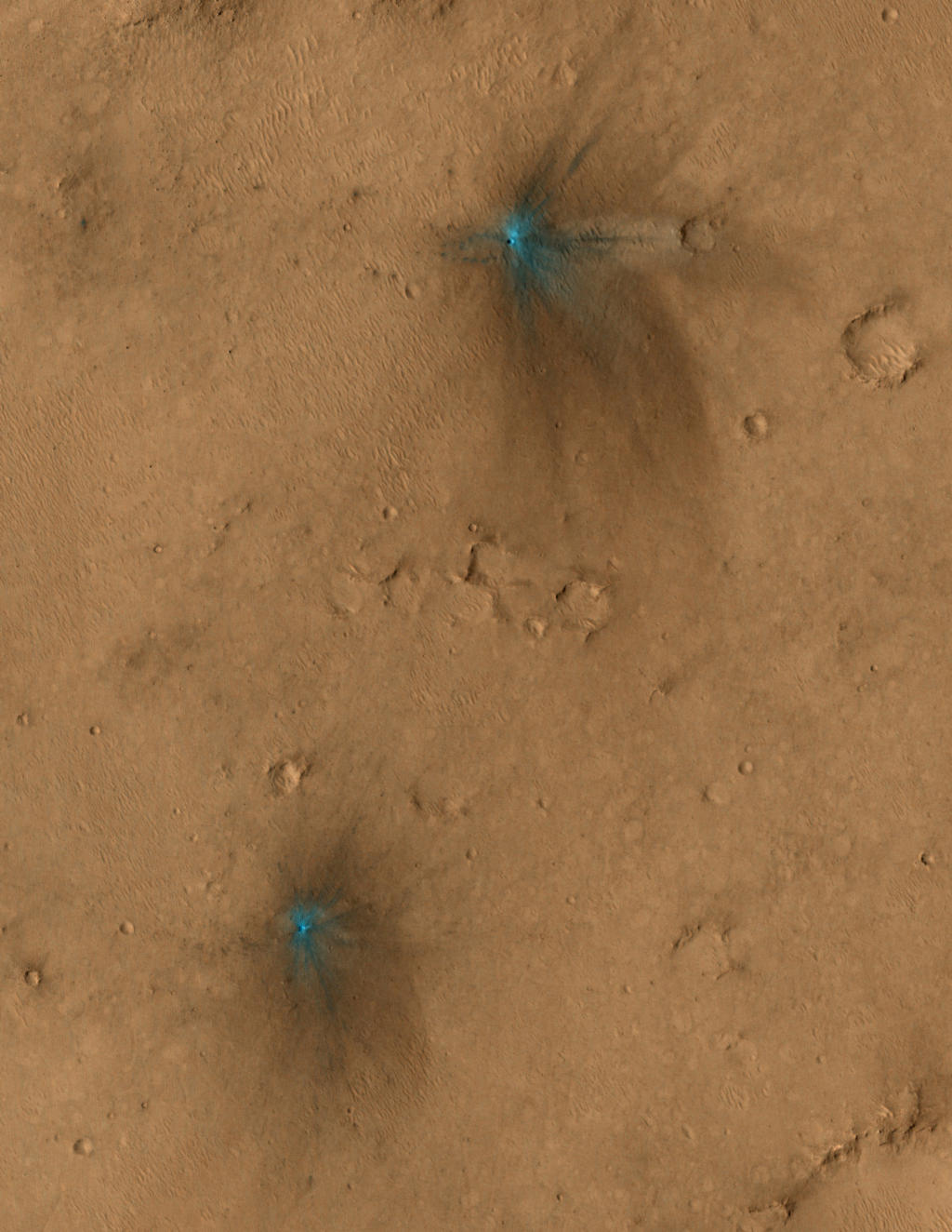 These images from the NASA Mars Reconnaissance Orbiter show several impact scars on Mars made by pieces of the NASA Mars Science Laboratory spacecraft that the spacecraft shed just before entering the Martian atmosphere.