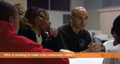 Who is working to make your community better? A JPL scientist sits among a group of teenagers talking.