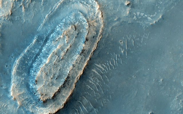 This image lies in the middle of a candidate landing site in the Northeast part of Syrtis Major, a huge shield volcano, and near the Northwest rim of Isidis Planitia, a giant impact basin.