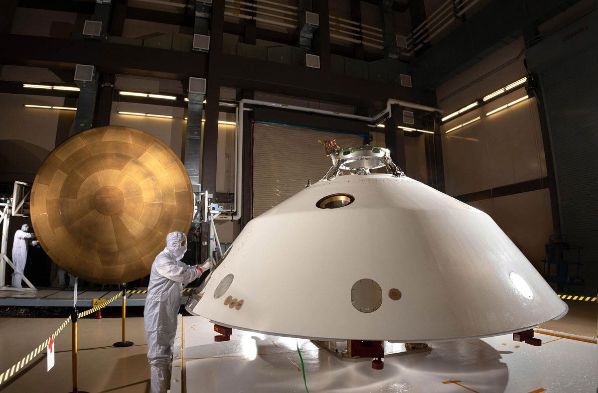 The heat shield (left) and back shell (right) that comprise the aeroshell for NASA's Mars 2020 mission are depicted in this image.