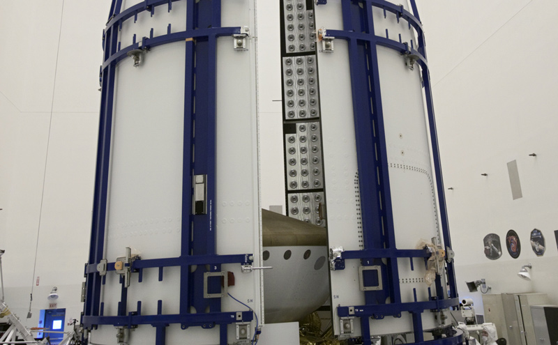 In the Payload Hazardous Servicing Facility at NASA's Kennedy Space Center in Florida, sections of an Atlas V rocket payload fairing obscure NASA's Mars Science Laboratory (MSL) from view as they close in around it.