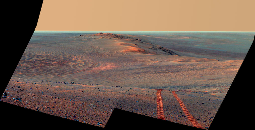 This Aug. 15, 2014, scene from the Pancam on NASA's Mars Exploration Rover Opportunity looks back toward part of the west rim of Endeavour Crater that the rover drove along, heading southward, during the summer of 2014. This version is in false color, making the rover's wheel tracks more apparent.