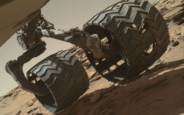 The team operating the Curiosity rover uses a camera on the rover's arm to check the condition of the wheels at routine intervals. This image of Curiosity's left-middle and left-rear wheels is part of an inspection set taken on Curiosity’s 1,179th Martian day, or sol, on Mars.