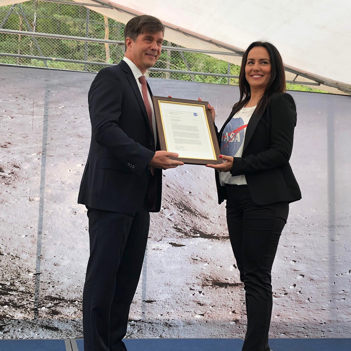 Eric Nelson, the U.S. Ambassador to Bosnia and Herzegovina, presents a framed letter to the Snezana Ružičić, mayor of the Balkan municipality of Jezero. The letter, from NASA's director of Mars Exploration, James Watzin, honored the connection between the small Balkan town and Jezero Crater the landing site of NASA's upcoming Mars 2020 mission.