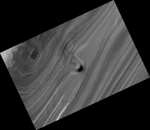 This image from the High Resolution Imaging Science Experiment (HiRISE) camera on NASA's Mars Reconnaissance Orbiter shows a mound within the area of a trough cutting into Mars' north polar layered deposits.