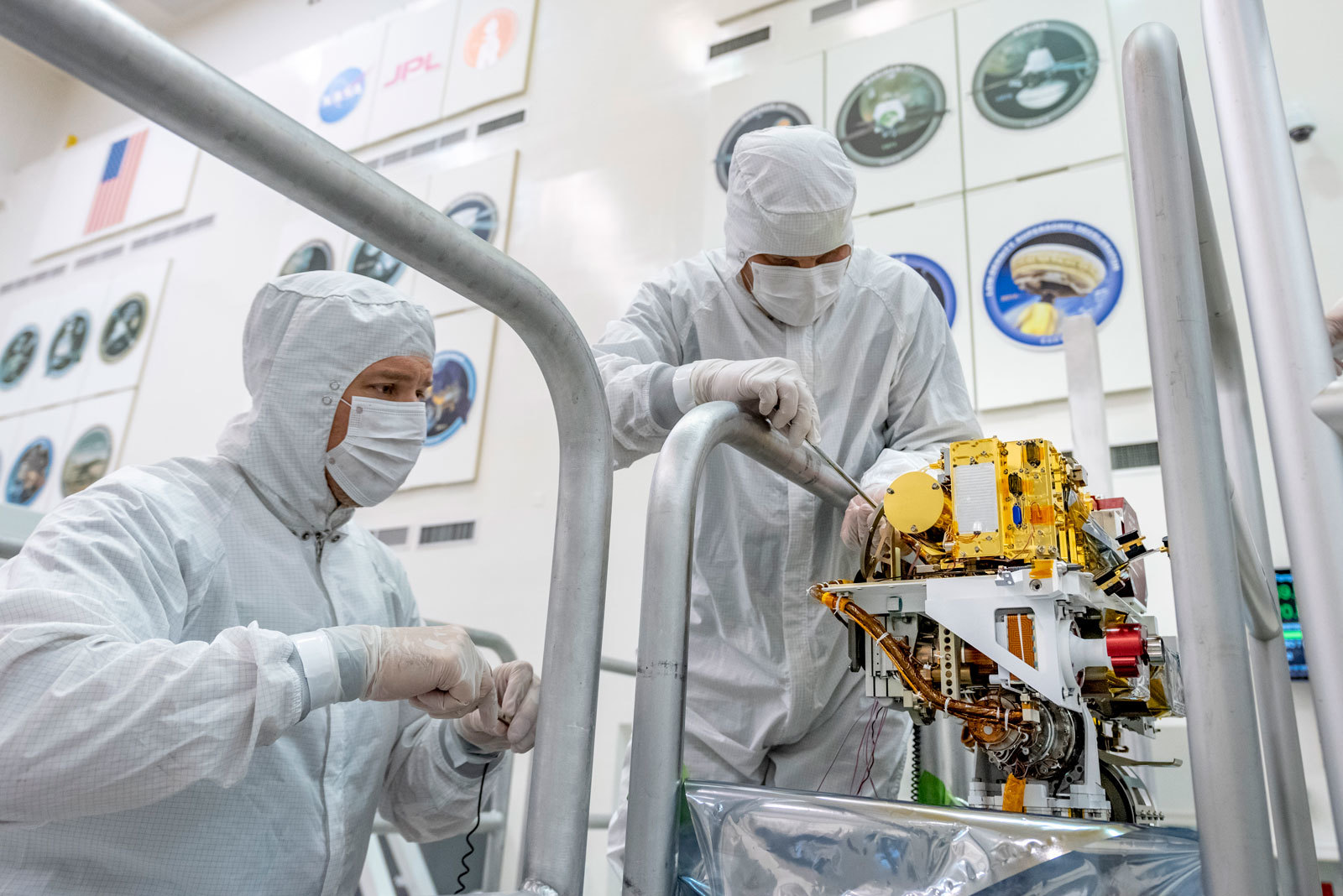 Engineers install the SuperCam instrument on Mars 2020's rover. This image was taken on June 25, 2019, in the Spacecraft Assembly Facility at NASA's Jet Propulsion Laboratory, Pasadena, California.