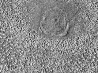 This image acquired on October 21, 2023 by NASAs Mars Reconnaissance Orbiter shows a relatively large (280-meter diameter) circular structure that is most likely a relaxed impact crater.