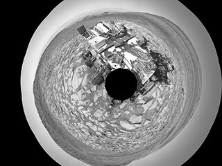 NASA’s Curiosity Mars rover captured this selfie using its left black-and-white navigation camera, which is mounted on its mast, or “head,” on Feb. 3, 2024, the 4,086th Martian day, or sol, of the mission. 